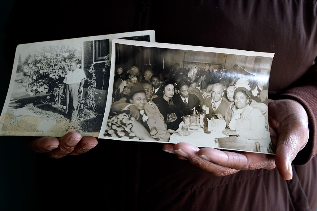 Ed Tibbs holds photos of his father